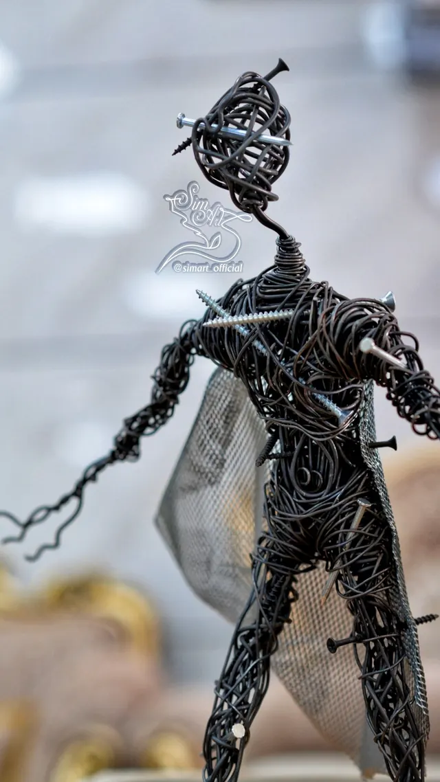 Nail-pierced figure — wire sculpture by Pouya