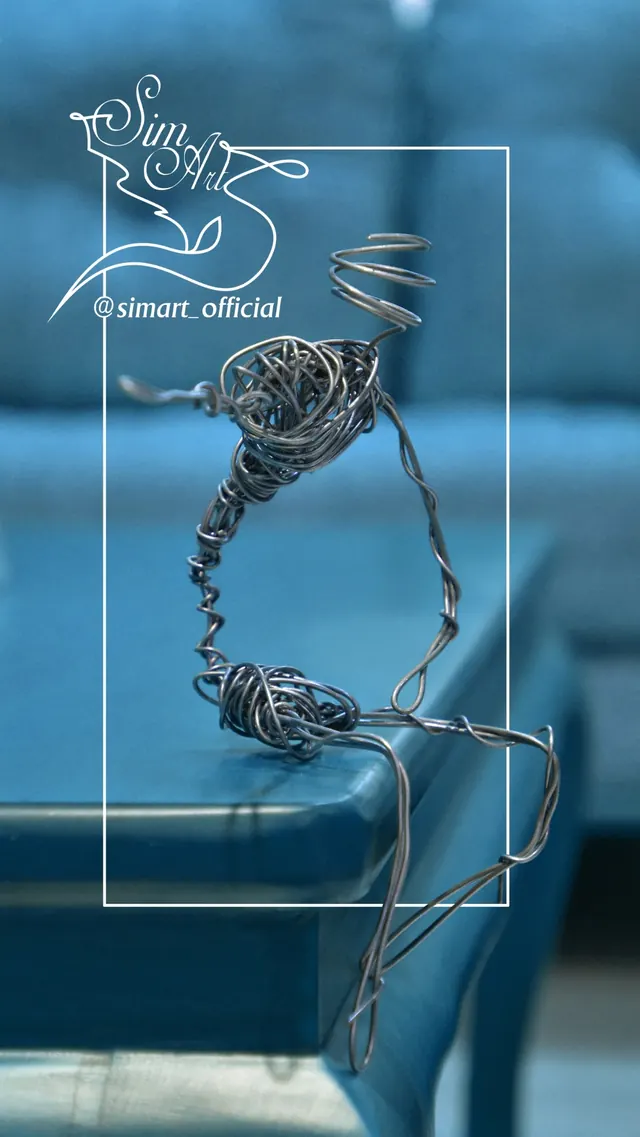 Figure on a table edge — wire sculpture by Pouya